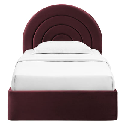Maroon velvet bed with rounded concentric-arch headboard and white bedding on a burgundy platform base.