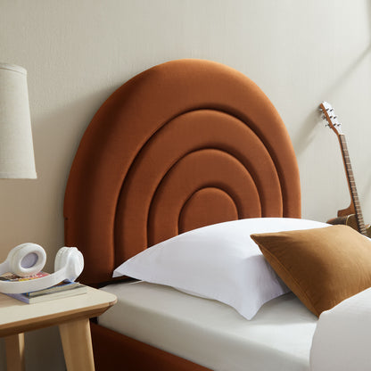 Burnt-orange, arc-shaped upholstered headboard with concentric arches; white bedding, brown pillow, guitar beside nightstand.