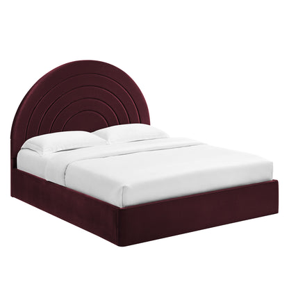 Purple velvet full platform bed with a rounded, multi-arch headboard and white bedding.