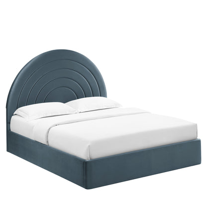 Dark blue upholstered platform bed with a rounded, concentric arc headboard and white bedding.
