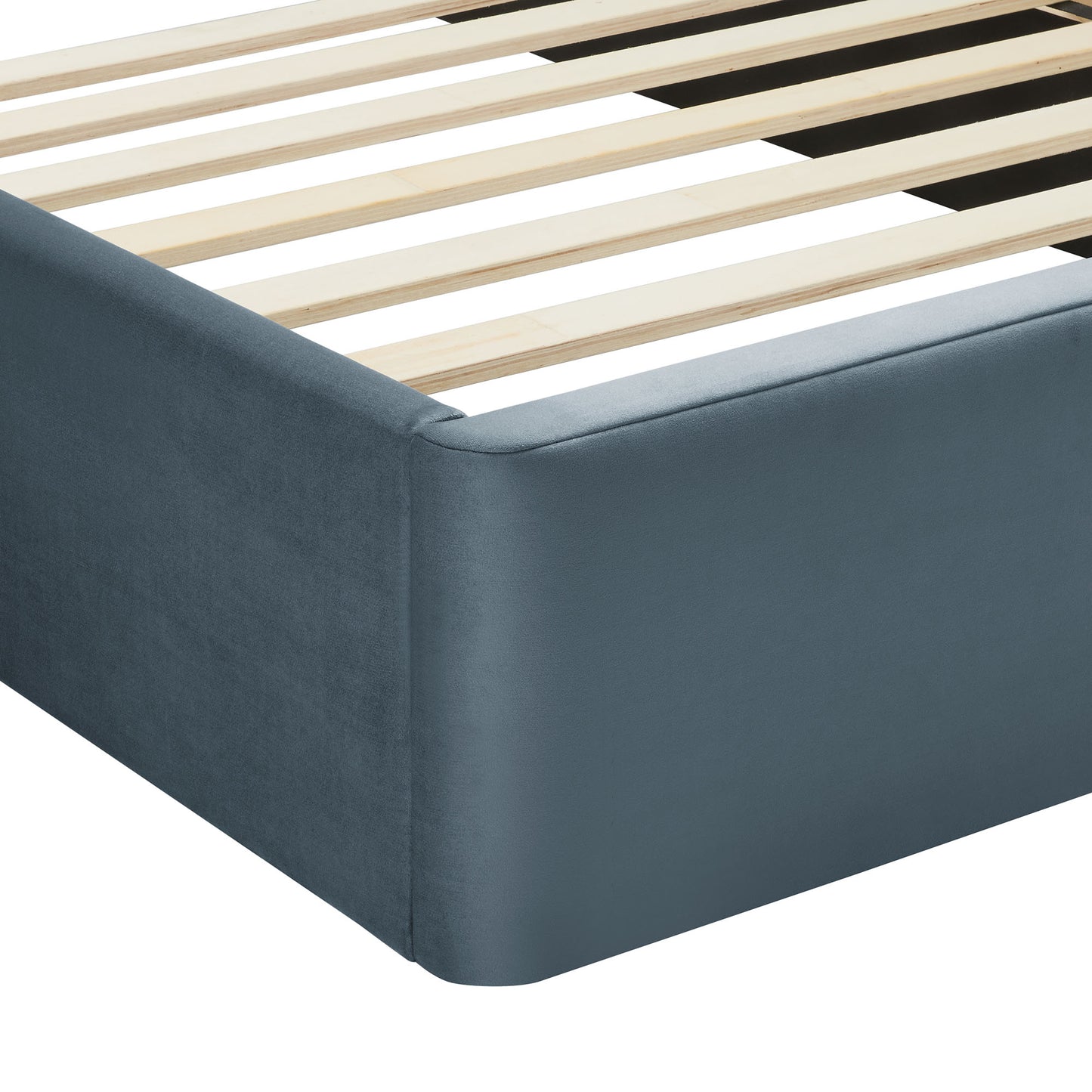 Blue velvet upholstered platform bed with an arched headboard and light wooden slats
