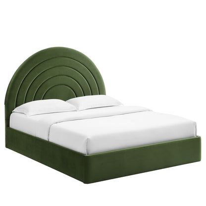 Green velvet platform bed with a layered, arched headboard and white bedding.