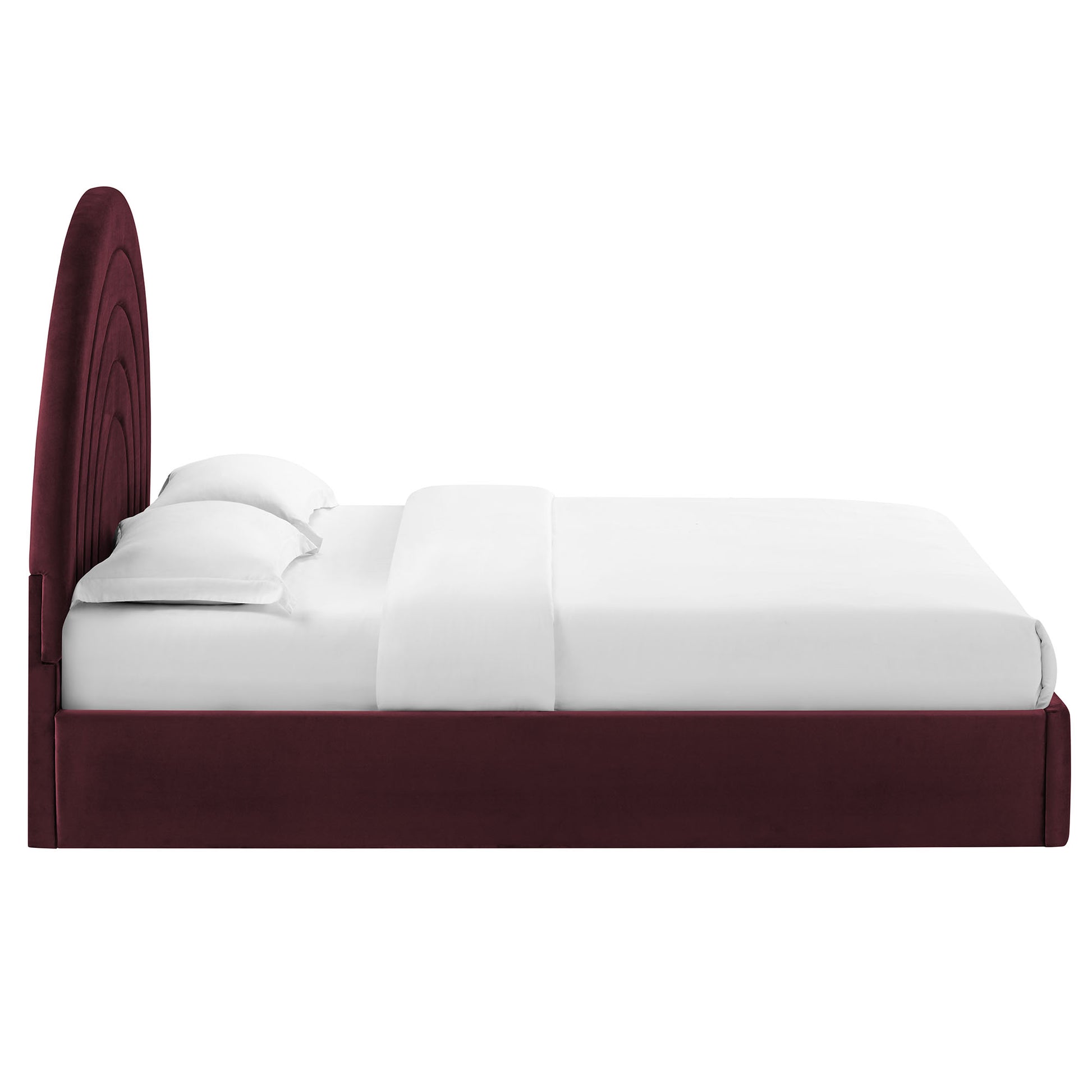 Purple velvet-like upholstered king platform bed with a curved arched headboard and low frame; white bedding.