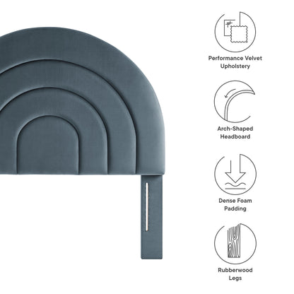 Arched headboard in blue performance velvet with layered curved panels, foam padding, and rubberwood legs.