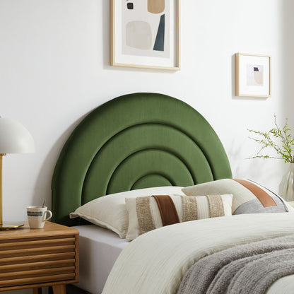 Green concentric-arc upholstered twin headboard with white bedding and neutral striped pillows, wooden nightstand.