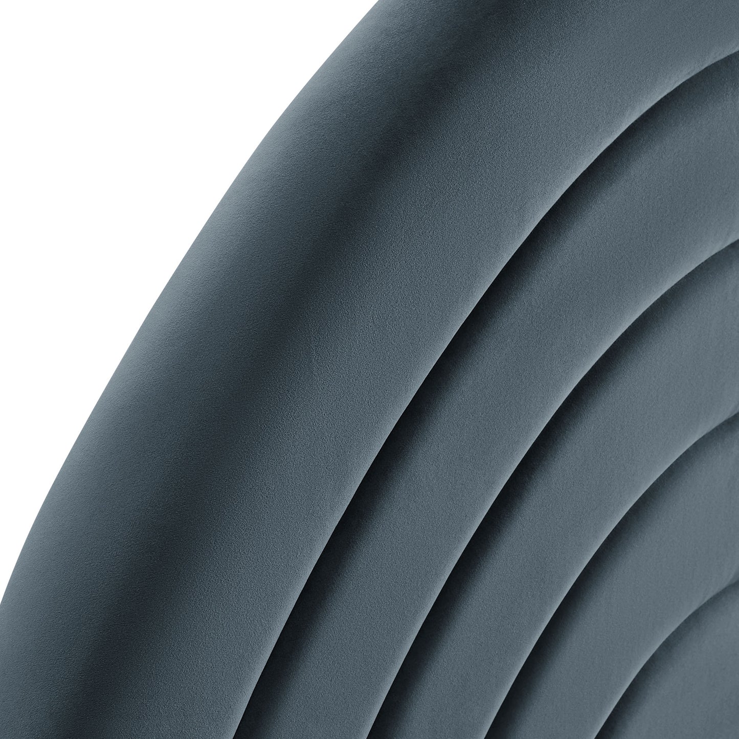 Close-up of blue-gray curved upholstered cushions with ribbed arches, modern lounge chair backrest.
