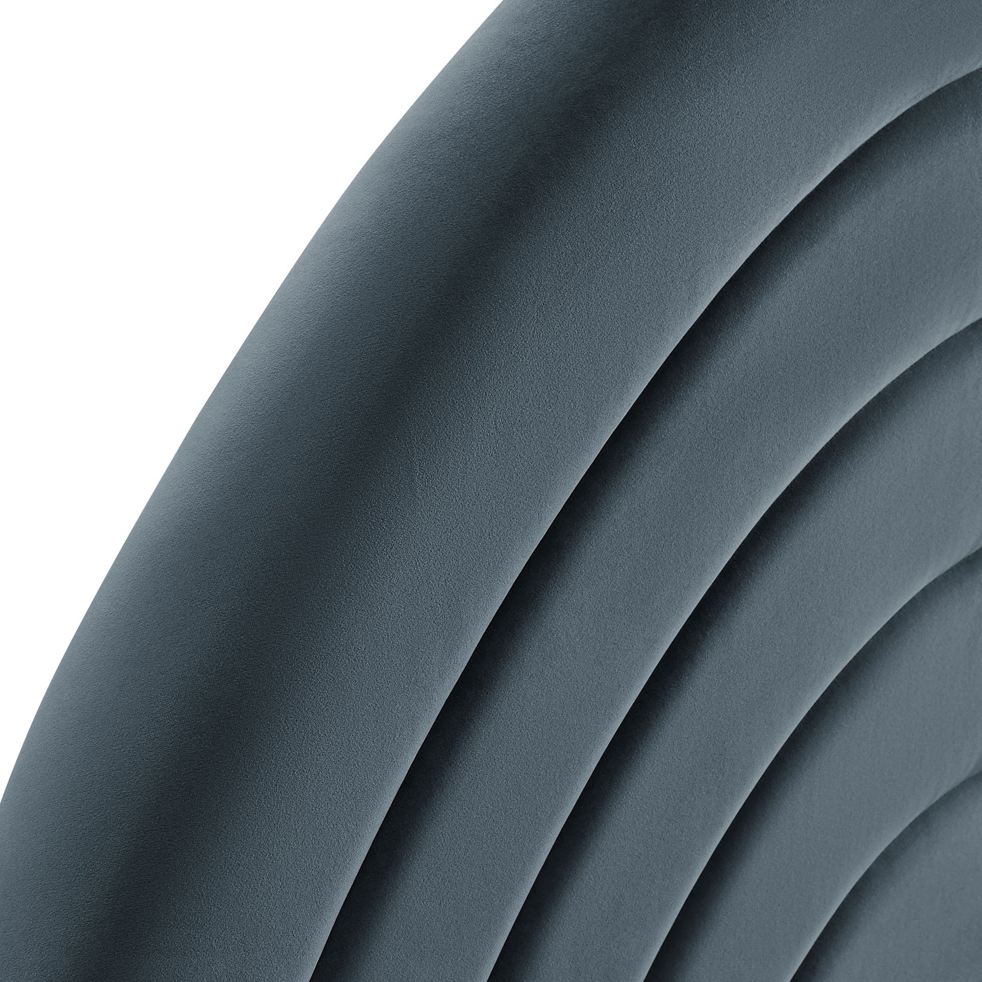 Close-up of blue-gray curved upholstered cushions with ribbed arches, modern lounge chair backrest.