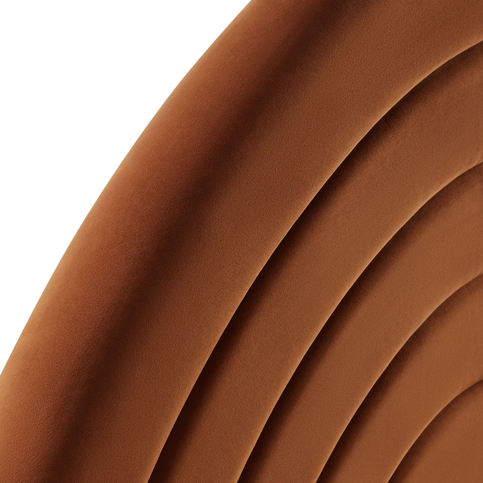 Cognac brown arched velvet headboard with a padded, curved silhouette.