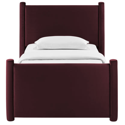 Maroon velvet upholstered bed with tall padded headboard and cylindrical corner posts, white bedding.