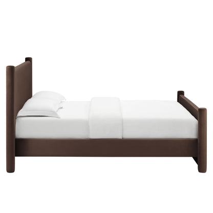 Chocolate brown velvet platform bed with tall rounded posts & white bedding.
