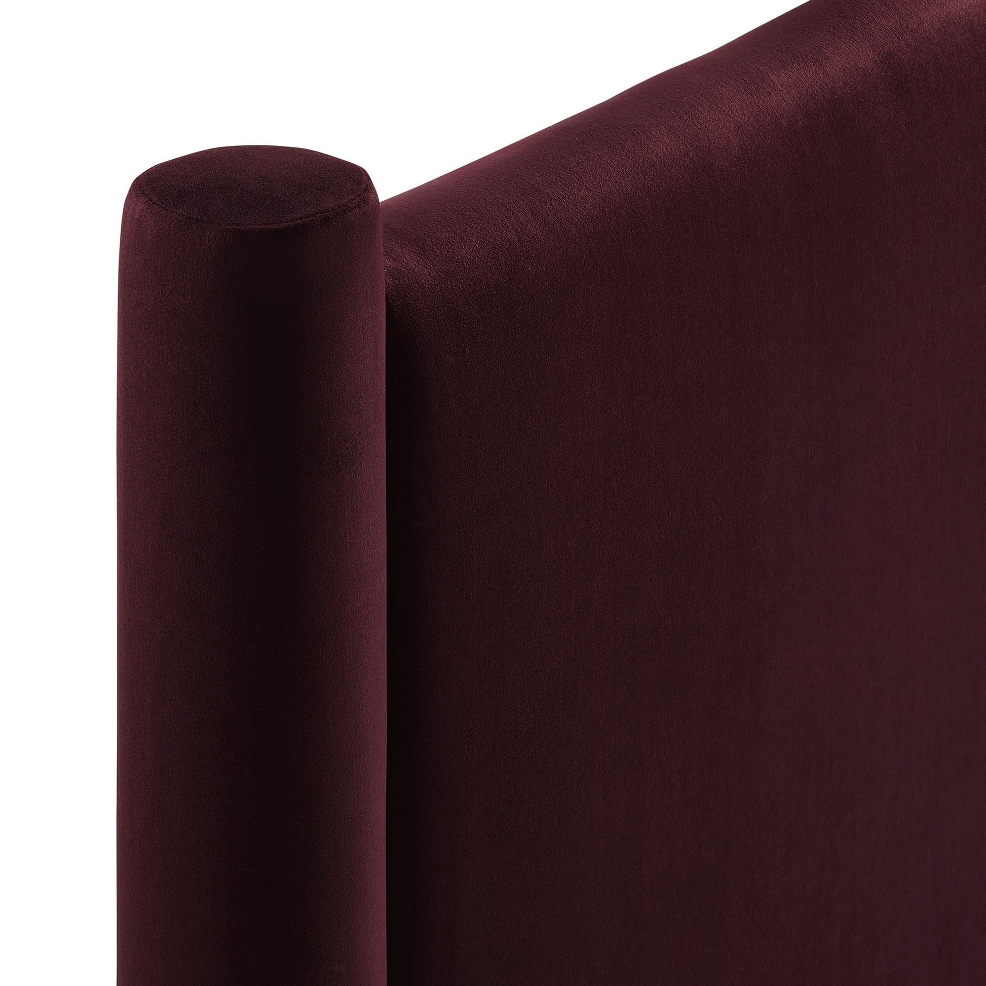 Maroon velvet upholstered sofa with a rounded cylindrical armrest and plush backrest.