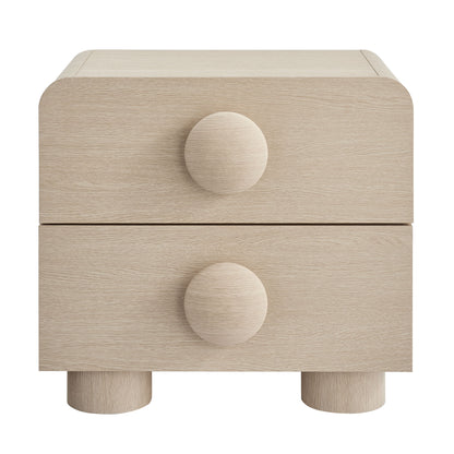 Natural ash wood two-drawer nightstand with rounded edges, circular knobs, and short cylindrical feet.