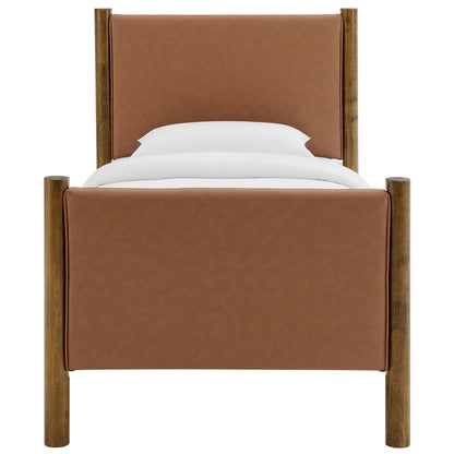 Tan leather upholstered bed with walnut-stained round wooden posts & rails, white pillows & duvet.