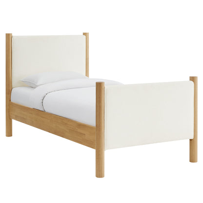 Twin bed with natural oak frame and ivory bouclé upholstered headboard and footboard; simple modern design.