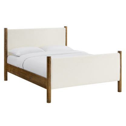 Bed with ivory boucle upholstered headboard and footboard, warm walnut wood frame, white bedding.
