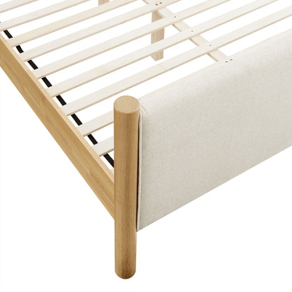 Ivory fabric-upholstered platform bed with a slatted base.