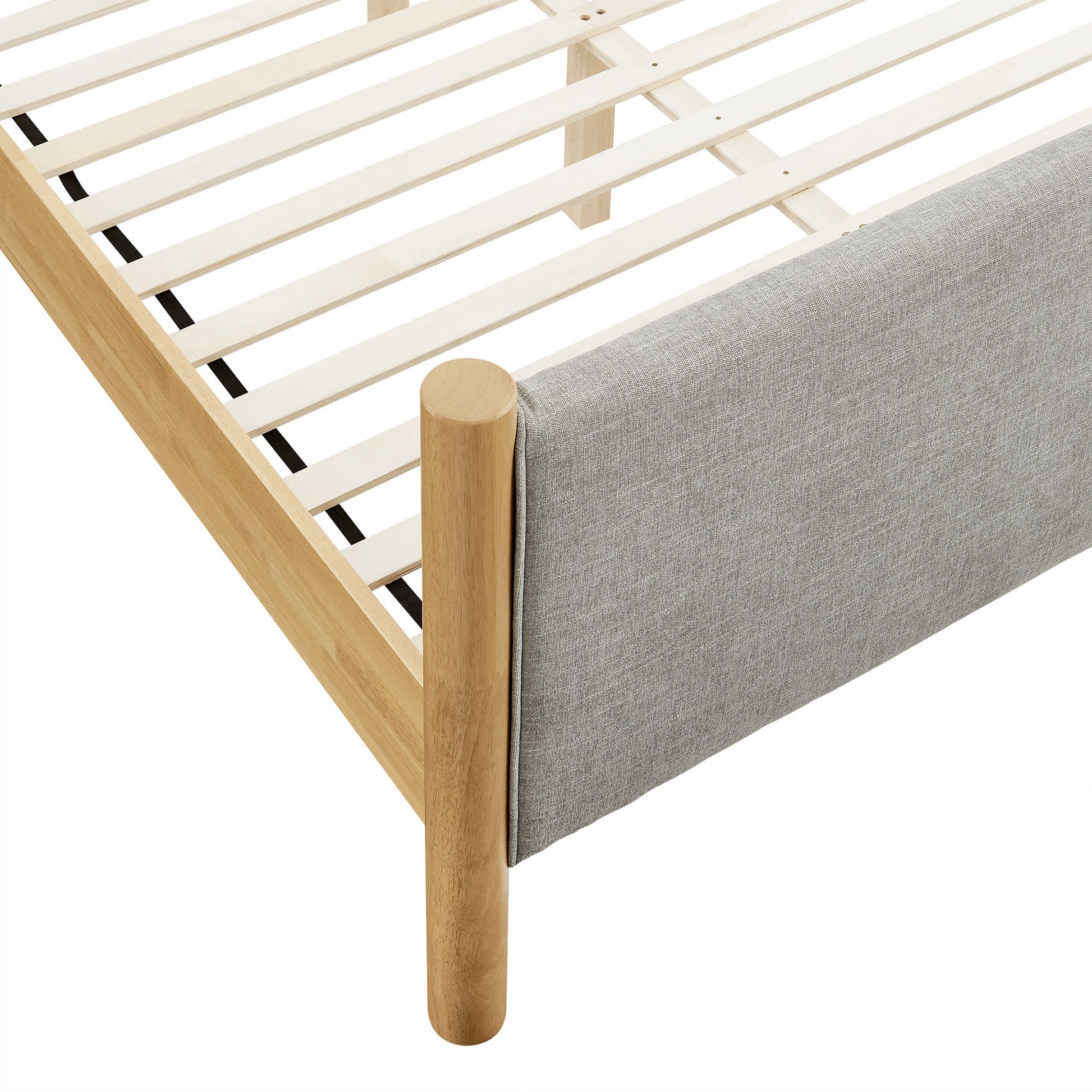 Oatmeal fabric upholstered queen-size platform bed with a low-profile frame.