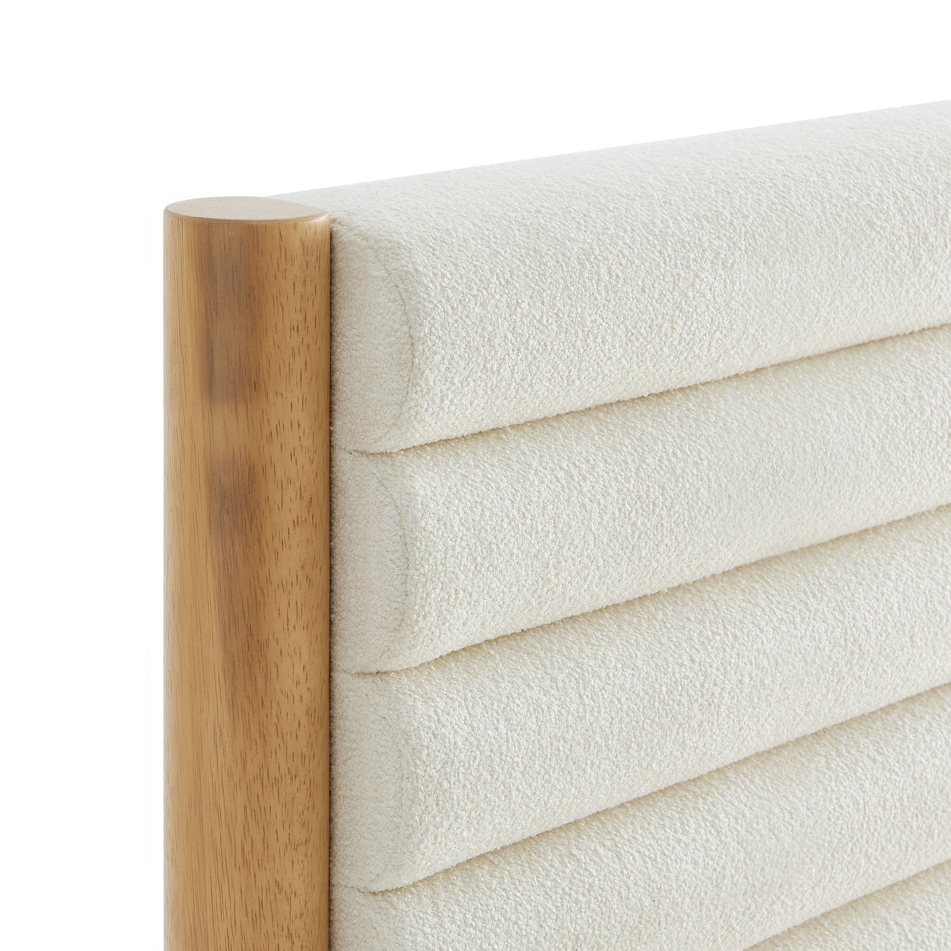 Oak-framed headboard with cream textured fabric and horizontal channel tufting; rounded wooden post on left.