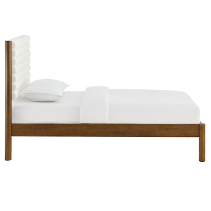 Walnut wood twin platform bed with a channel-tufted boucle headboard.