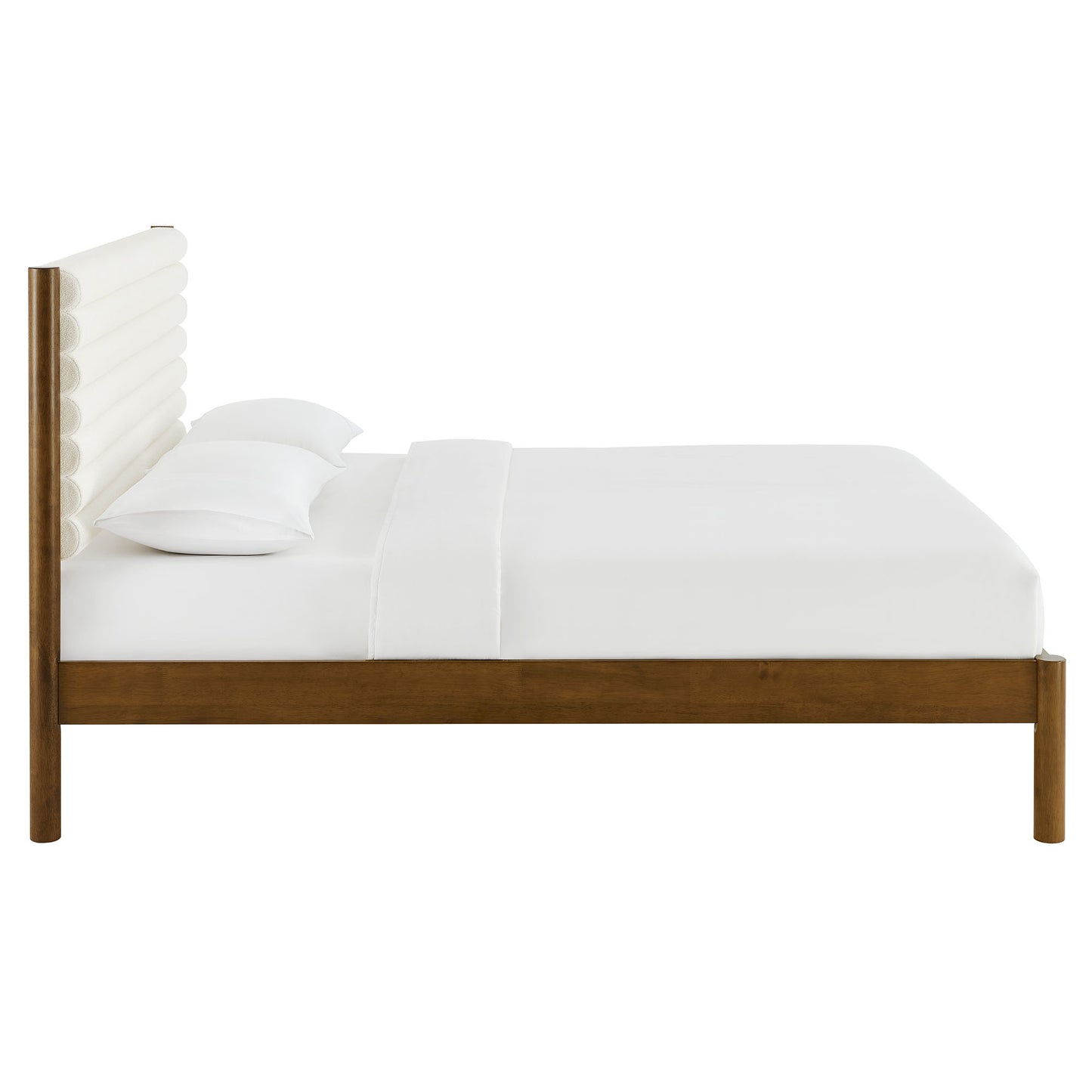 Walnut platform bed with white padded cylindrical headboard and crisp white bedding