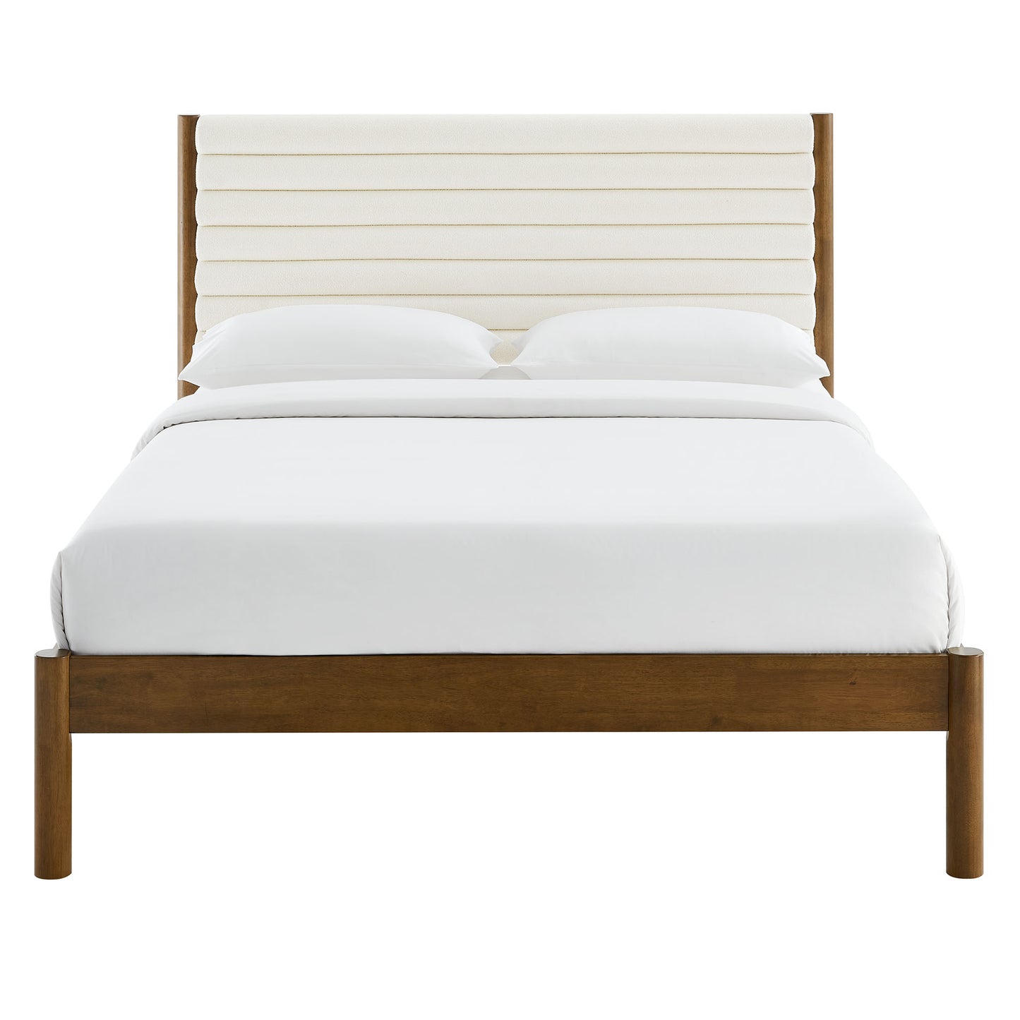 Walnut wooden platform bed with a cream channel-tufted boucle headboard and white bedding.