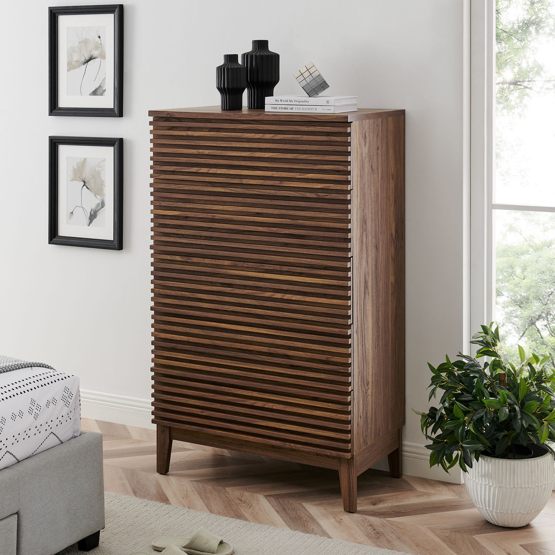 Walnut mid-century 5-drawer chest on four legs, top with vases and books.