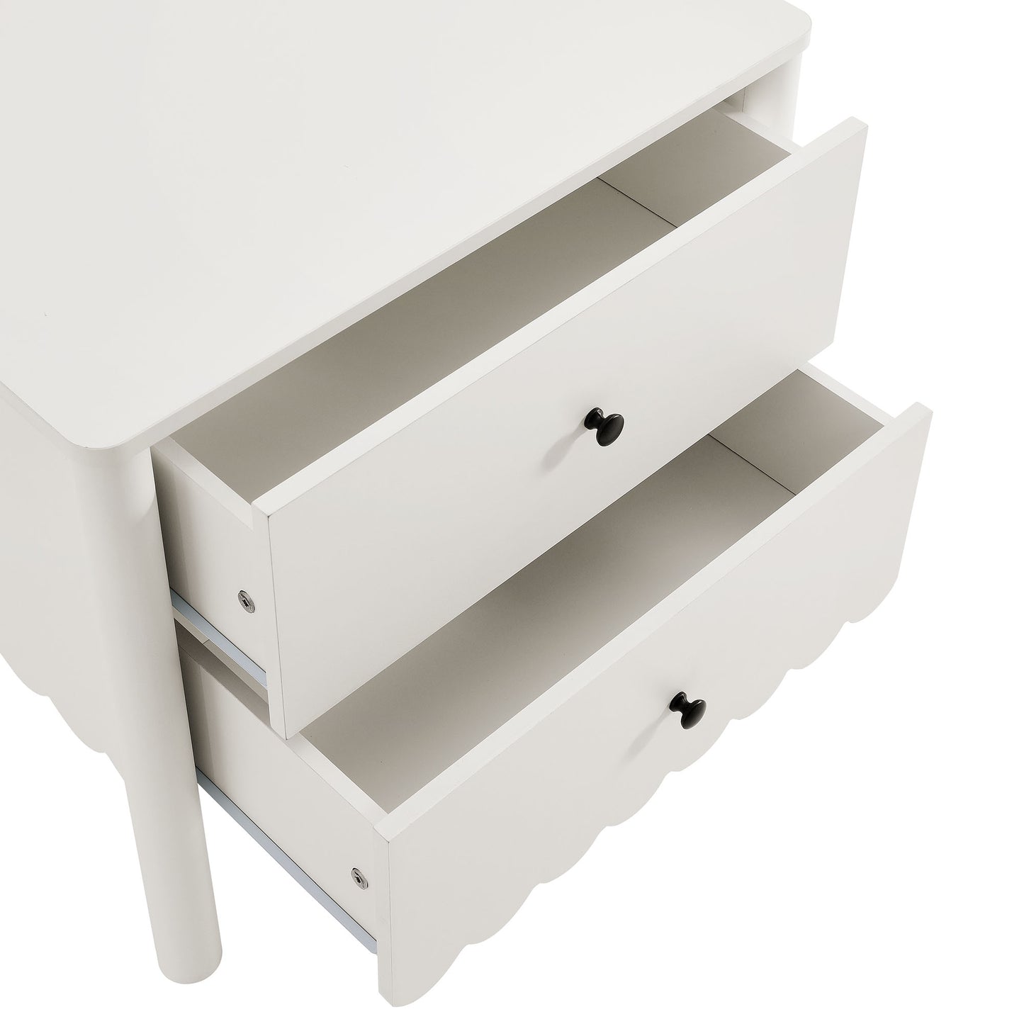 White wooden three-drawer nightstand with black knobs and a scalloped bottom drawer.