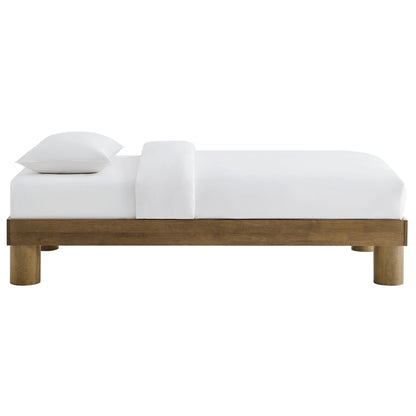 Natural wood platform bed with white bedding and two pillows, minimalist modern style.
