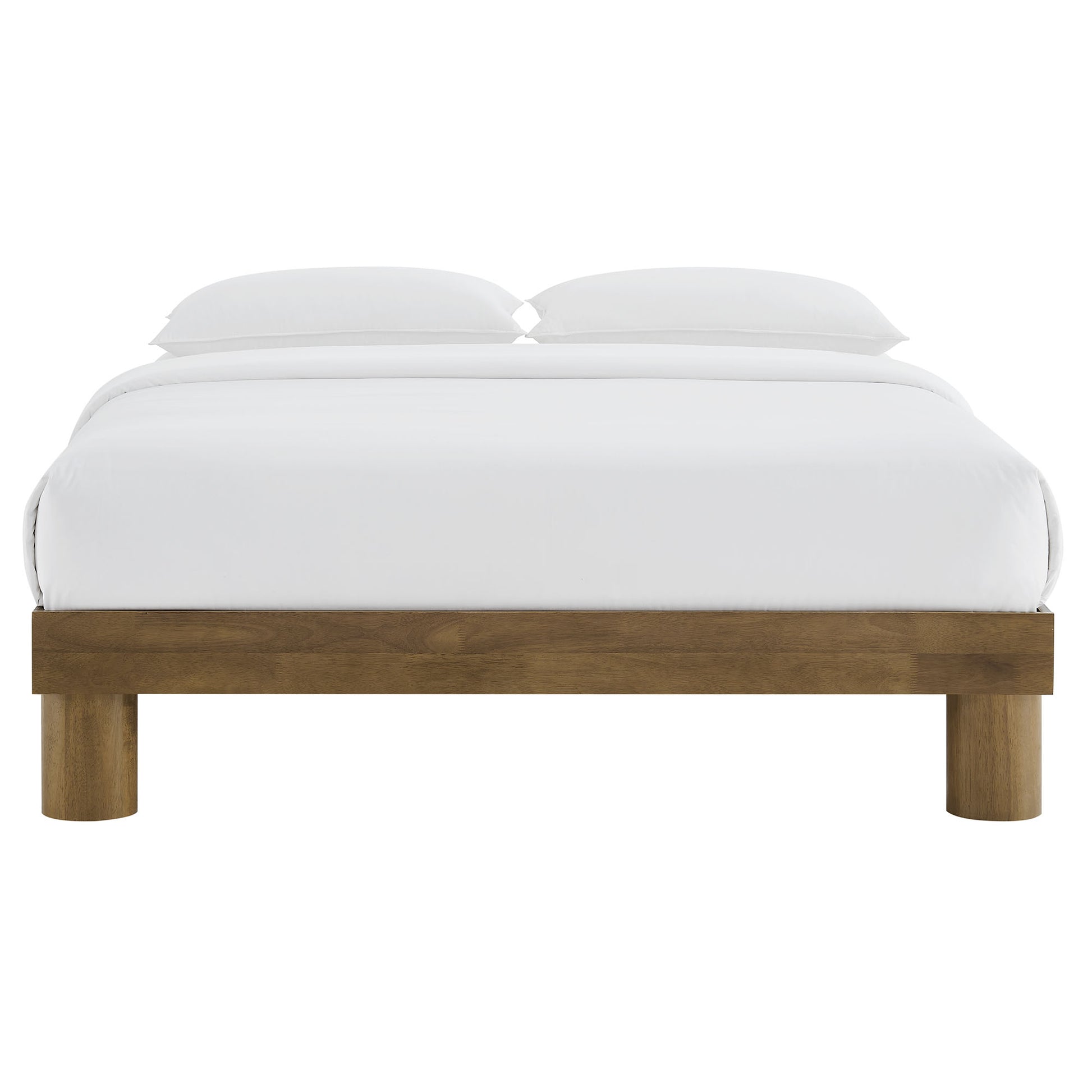 Natural wood platform bed with white bedding and two pillows, low-profile frame with chunky square legs.