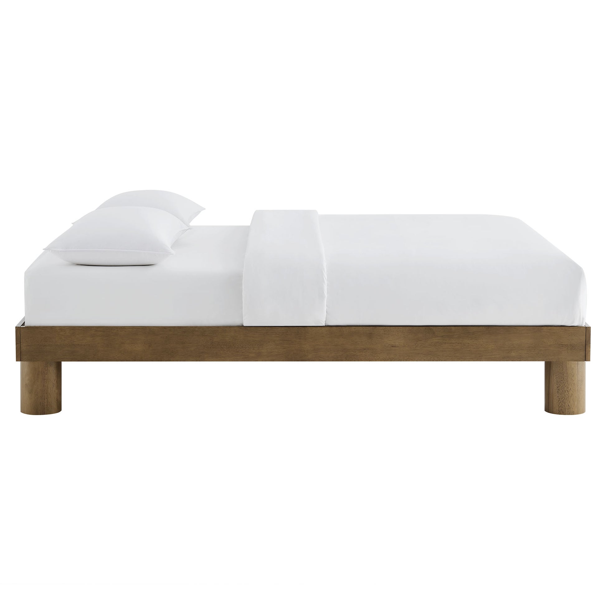 Low-profile brown wood king platform bed with white bedding and two pillows.