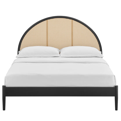 Black queen arched rattan cane platform bed with white bedding.