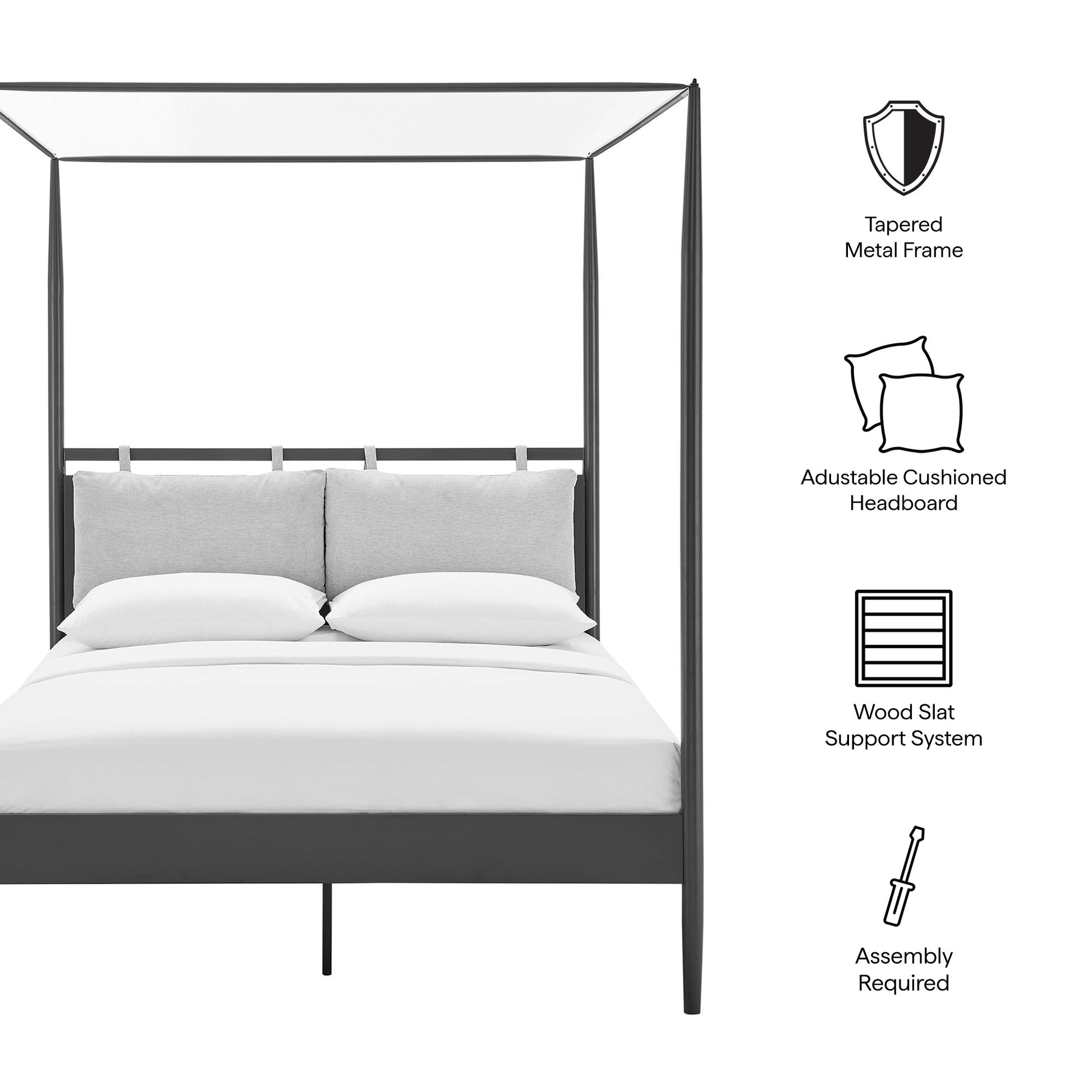 Dark metal four-poster canopy bed with gray cushioned headboard and white bedding.