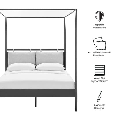 Dark metal four-poster canopy bed with gray cushioned headboard and white bedding.