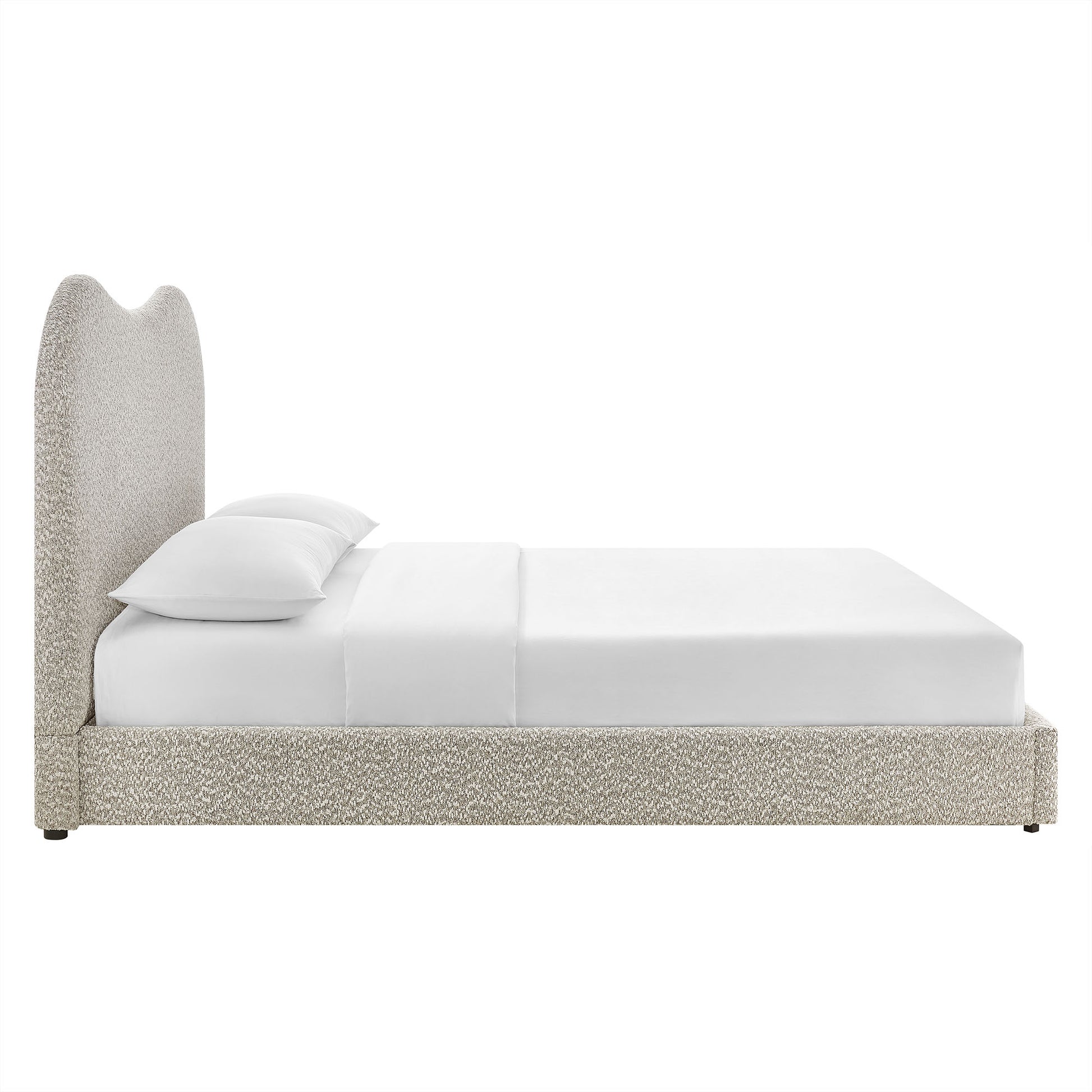 Beige boucle upholstered bed with tall curved headboard, low platform, white bedding and pillows.