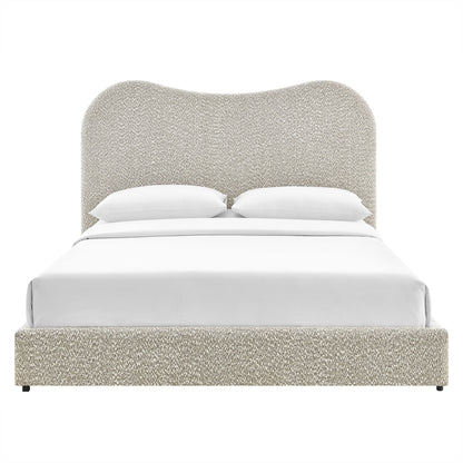 Beige boucle upholstered platform bed with rounded tall headboard and white bedding.