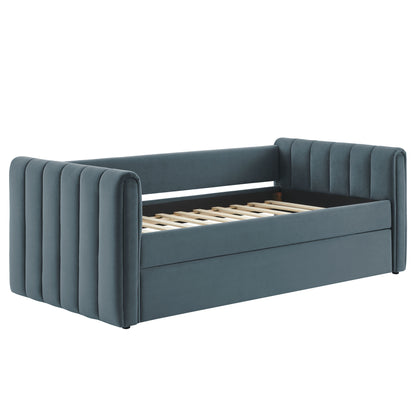 Blue velvet twin daybed frame with vertical channel tufting on ends and a trundle.
