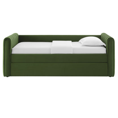 Moss green velvet twin daybed with channel tufting and trundle, shown with white sheets and a pillow.