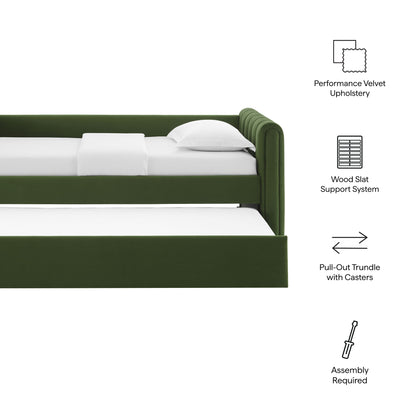 Moss green velvet twin daybed with pull-out trundle on casters and white bedding.
