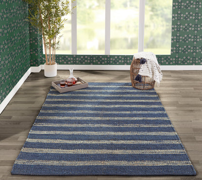 Textured woven navy blue rug with beige stripes, rectangular on a wood floor in a cozy living area.