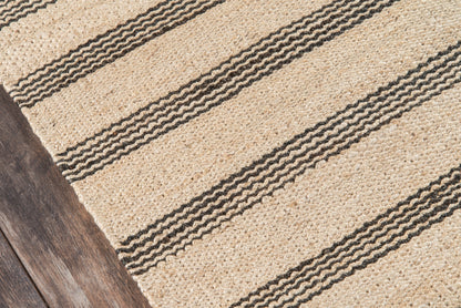 Beige natural jute rug with dark striped bands on a dark wood floor.