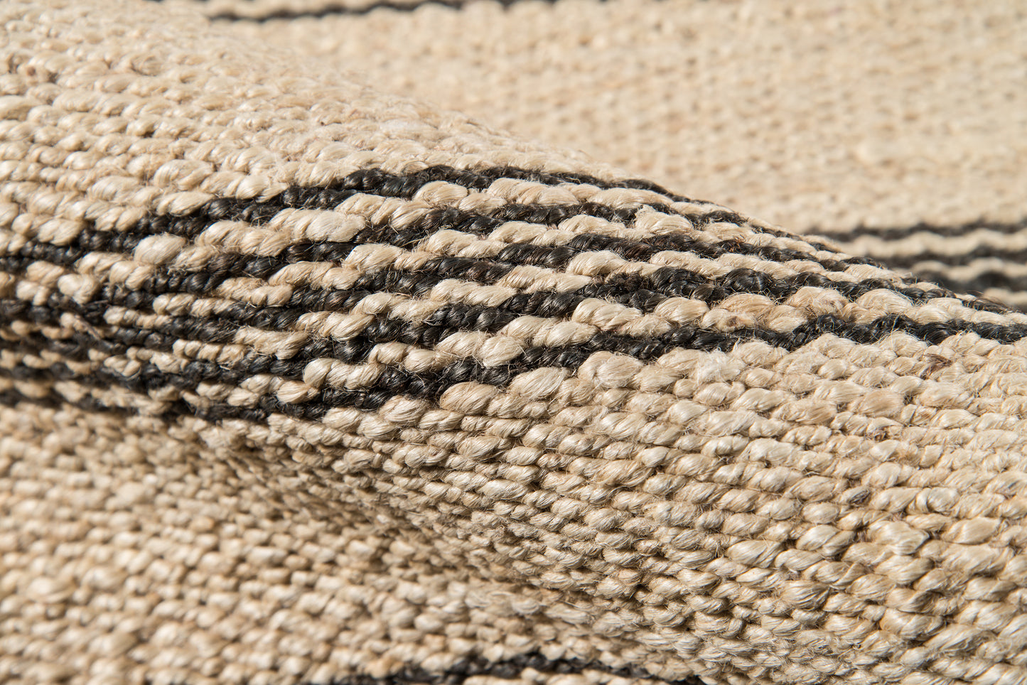 Beige woven jute runner with a black stripe pattern and textured braided weave for a rustic coastal look, 2' x 10'.