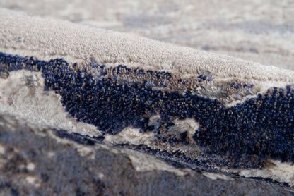 Cream beige and navy blue shag rug with abstract wave pattern and dense plush pile.