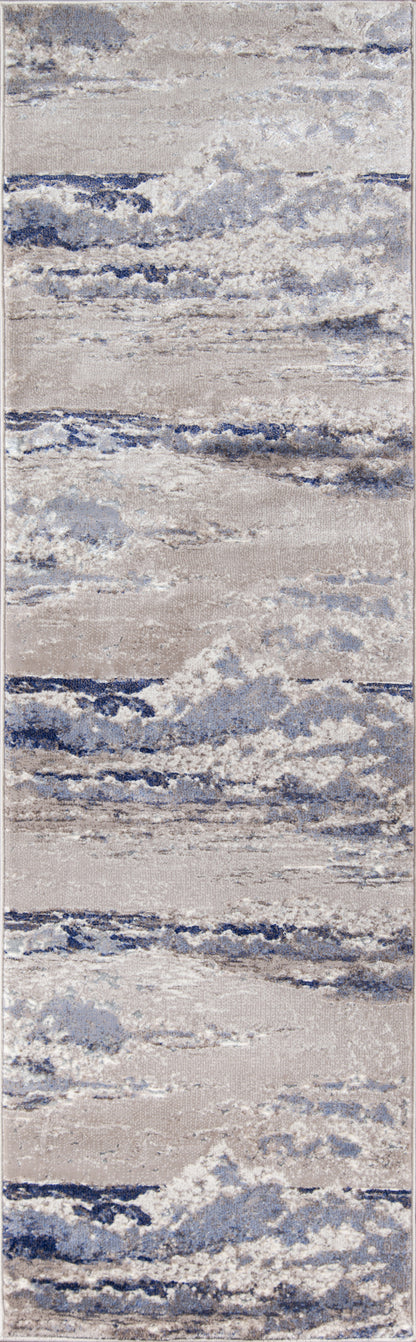 Rectangular area rug with abstract blue, gray and beige pattern; soft textured pile for modern coastal decor.