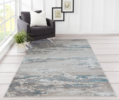 Blue-gray abstract rug on the floor, 2' x 3'.