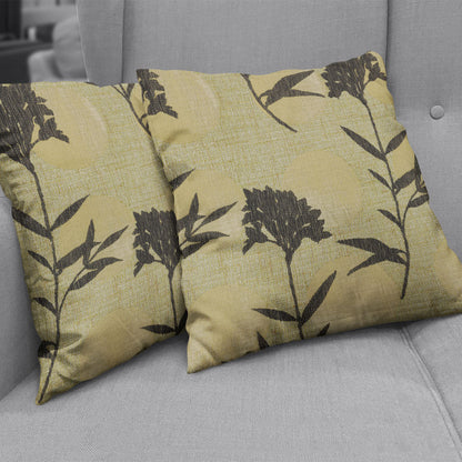 Pistachio geometric-patterned throw pillows on a light gray sofa.