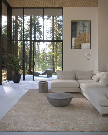 Modern living room with neutral sectional, concrete coffee table, beige rug, floor-to-ceiling windows and abstract art.