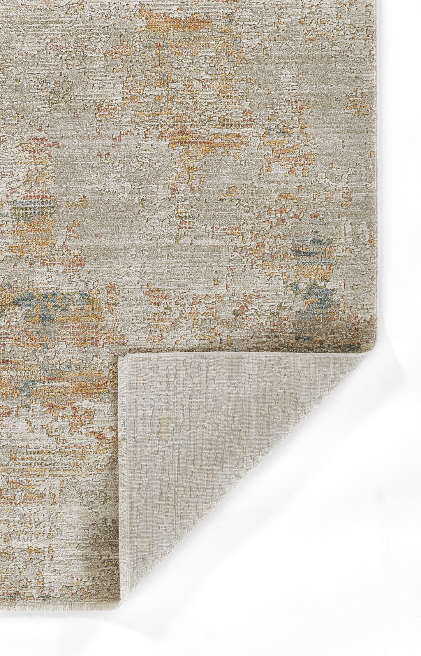 Beige abstract distressed area rug with muted rust, gold, and blue accents; folded corner shows light beige backing.