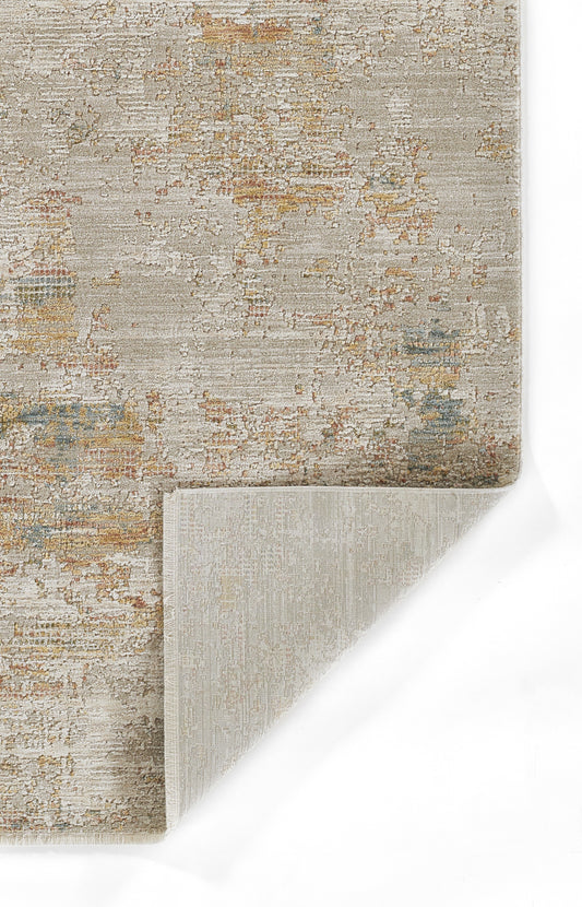 Beige abstract distressed area rug with muted rust, gold, and blue accents; folded corner shows light beige backing.
