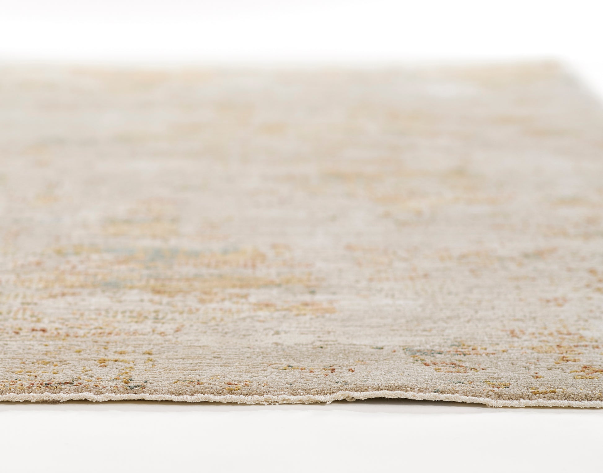 Beige flat-weave area rug with subtle pastel specks and a light fringe edge.