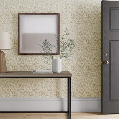 William Morris Willow Boughs Wallpaper in Linen by Morris & Co with flowing willow branches and delicate botanical leaves in soft neutral linen tones. Classic Arts & Crafts wallpaper for elegant living rooms, bedrooms, dining rooms, hallways, and feature walls.